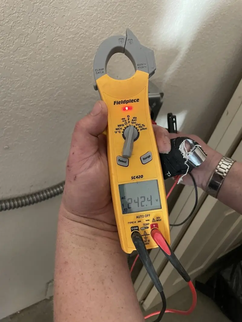 Voltage testing with clamp meter during Electrical Installation Services in Weston